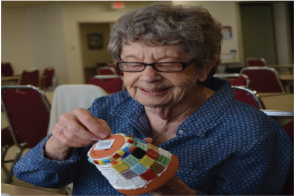 Picture of a woman working on a project at the Senior Center