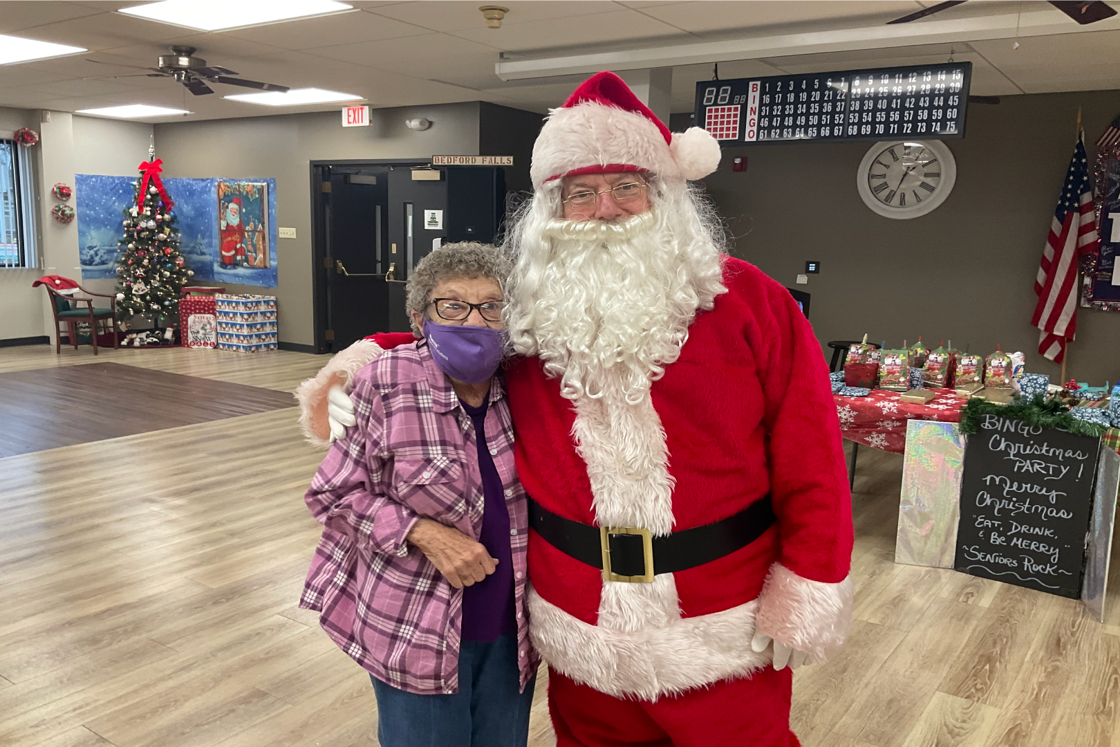 Picture of Santa hugging a woman at the Senior Center