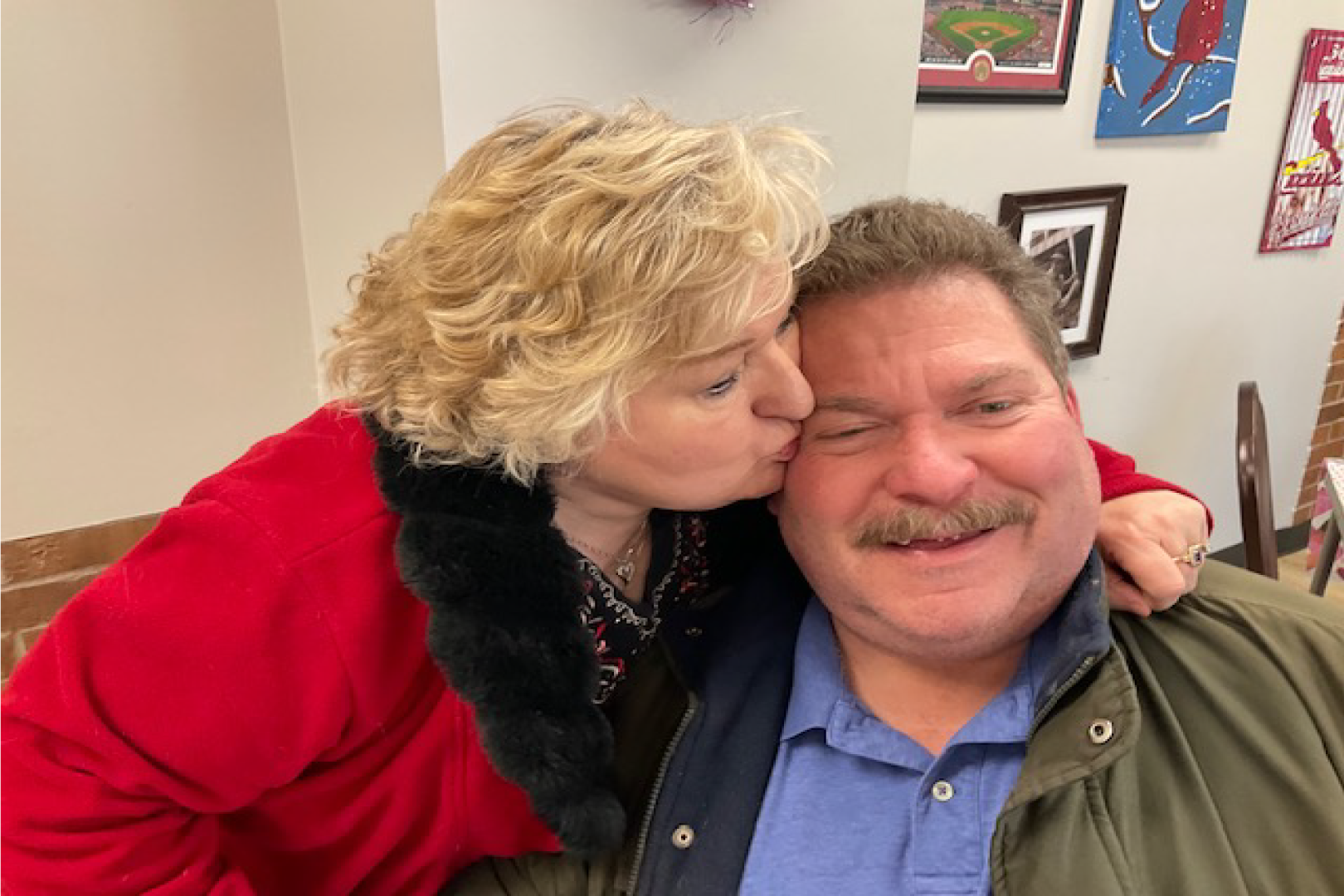 Picture of a woman kissing a man at the Senior Center