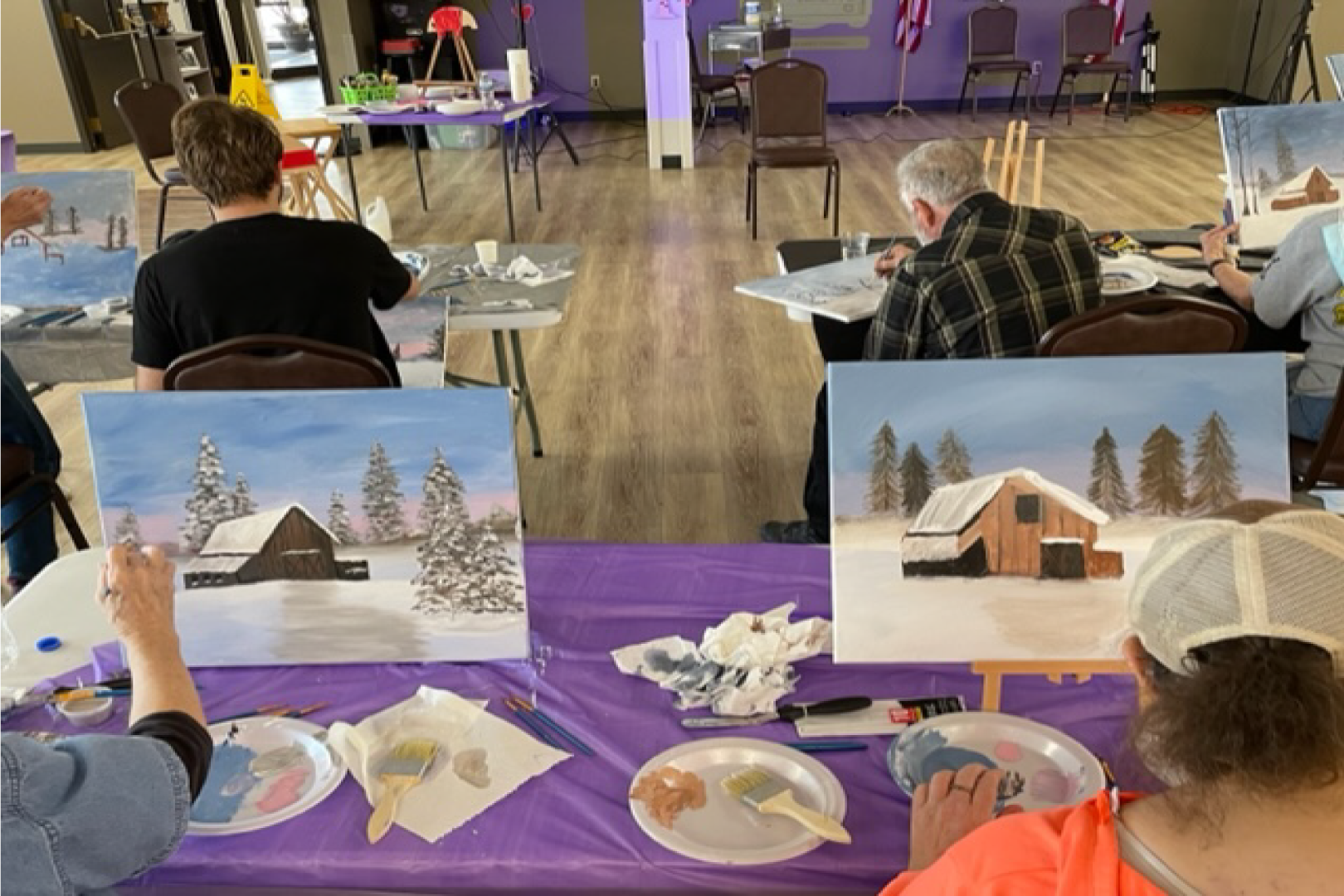 People painting pictures at the Senior Center