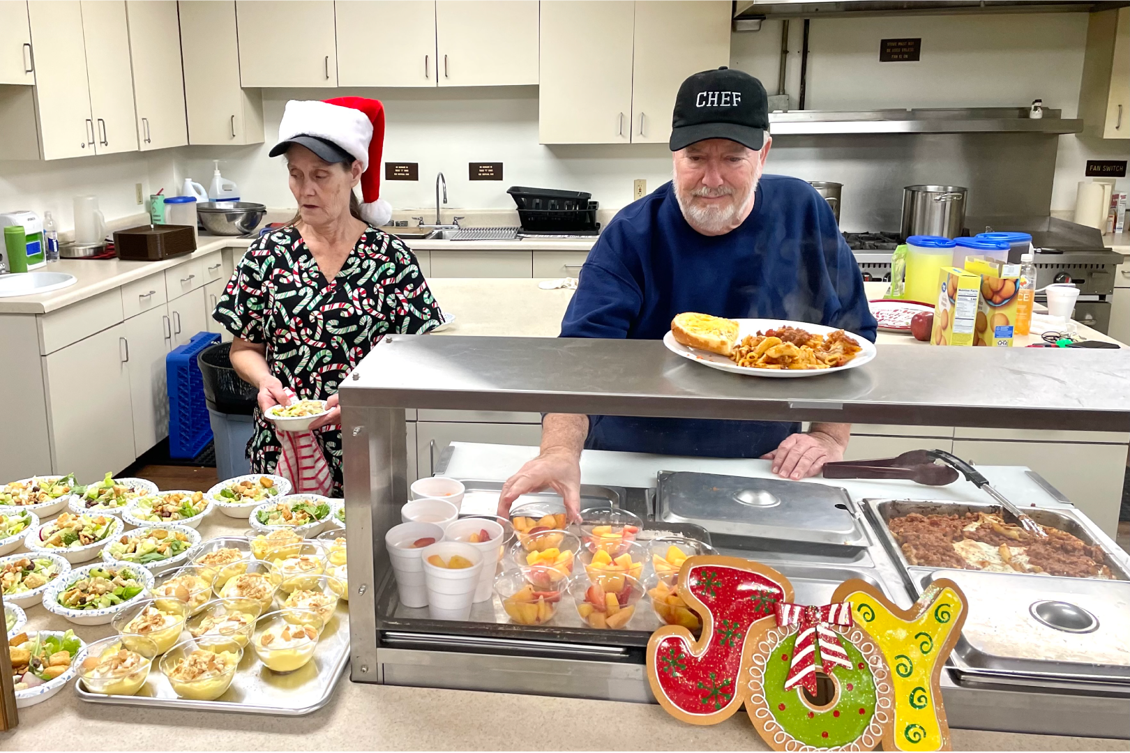 Picture of a man and woman prepairing food at the Senior Center