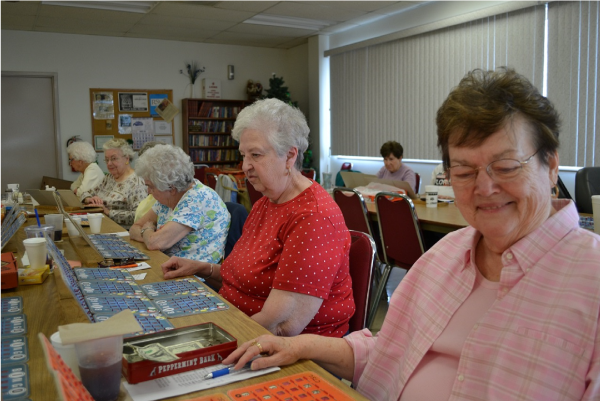 Picture of a group of women sitting at tables in the Senior Center